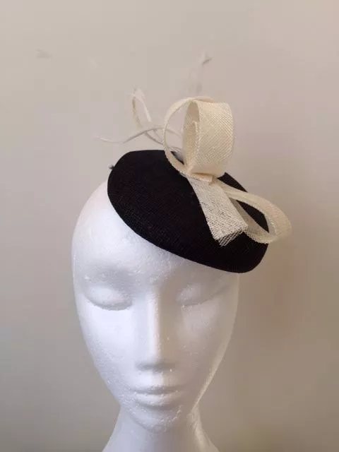 Beautiful black fascinator with white sinamay loops and feathers