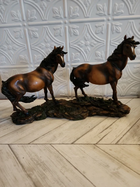 Horse figurine of two horses standing in grass