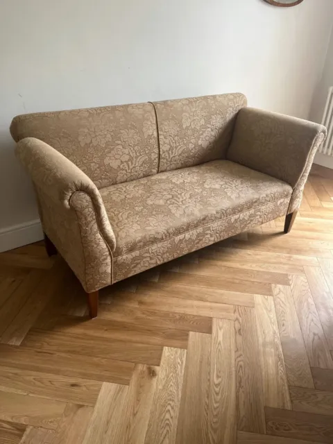 Victorian Sofa with drop arms, upholstered in gold damask.