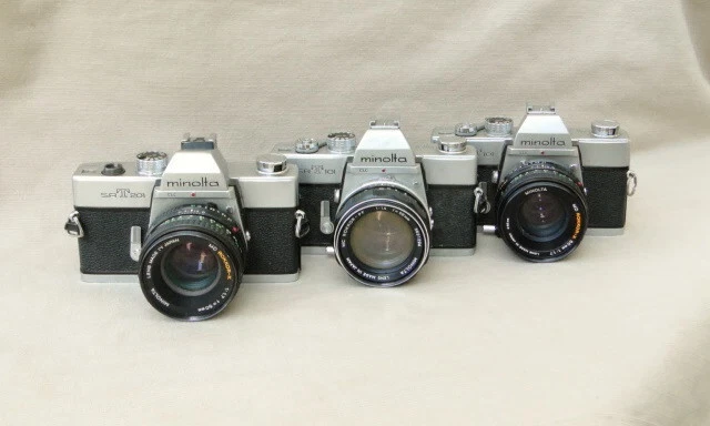 three Minolta SRT101 SRT201 cameras with lenses - parts or repair