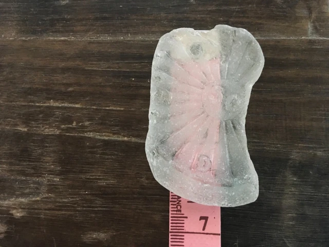 clear Brittany Sea surf tumbled sea glass piece sun rays w “50” in middle