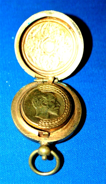 An antique brass sovereign case, King Edward VII internal profile, decorative