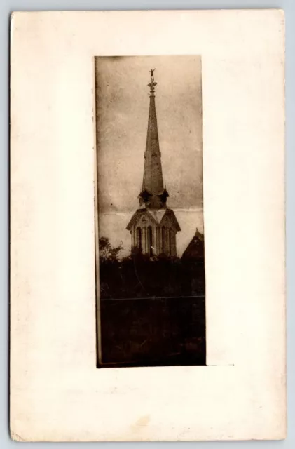 RPPC Chicago Publisher~Man (or Statue) Stands Atop Tall Steeple Cross c1910 PC