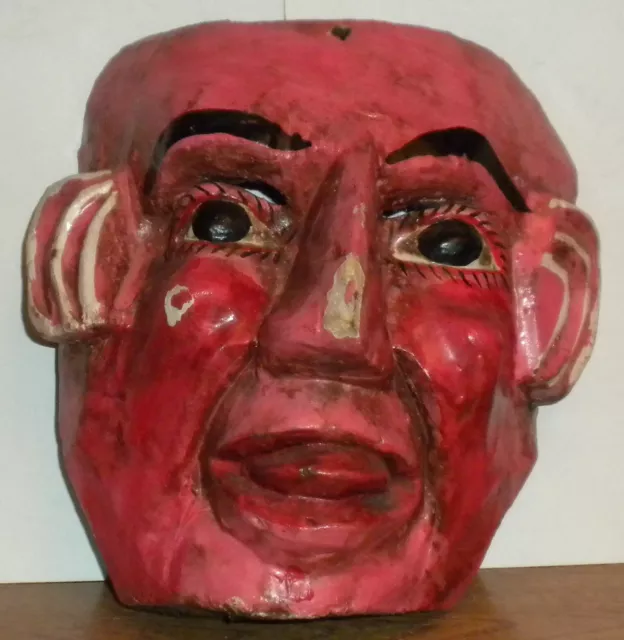 old wooden mask man's head in paint primitive