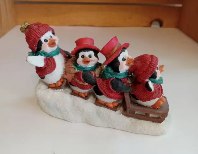 Four Penguins Sledding Down a Hill Holiday Figurine Resin Vintage ~5.75 x 4 in