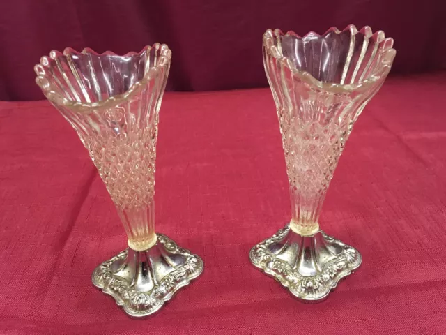 Pair of vintage ,pressed glass bud vases 6.5’in tall with silver plated bases.