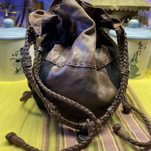The Sak Indio Patchwork Brown Black Leather Braided Drawstring Bucket Bag
