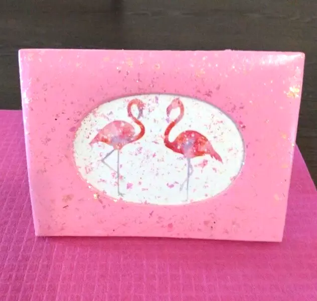 Flamingos framed in a bright pink sparkle paper mache frame