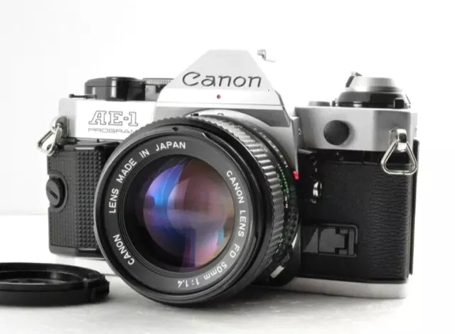 Cámara de película SLR plateada con programa Canon AE-1 casi perfecta con...