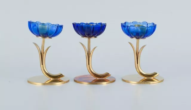 Gunnar Ander for Ystad Metall. Three candlesticks in brass and blue art glass