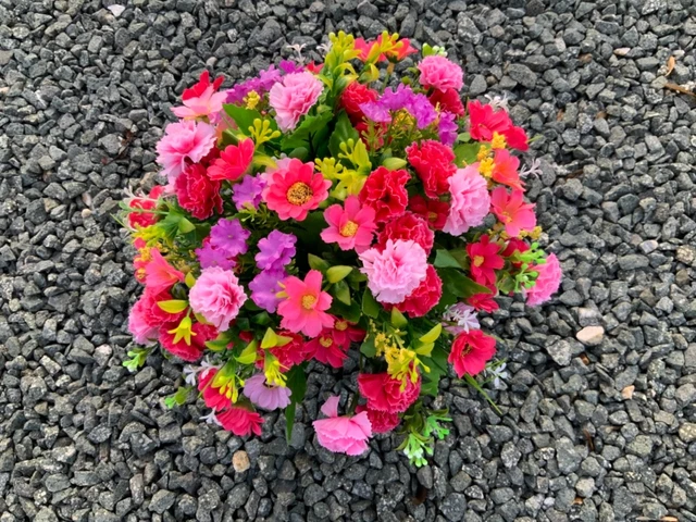 artificial pink mini carnation arrangement in grave/memorial/crem pot