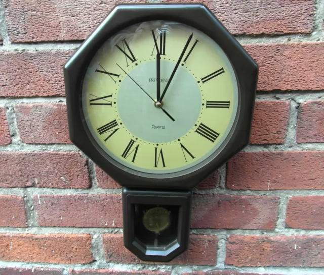 A 1980s President 'Drop Dial' Quartz Wall Clock - Moving Pendulum - Wood Effect.
