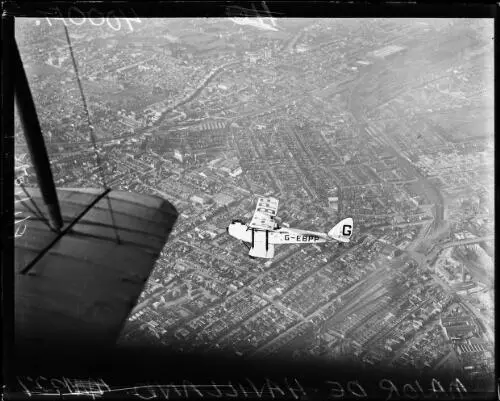 Aerial view of a de Havilland Golden Moth Puss Plane flying over a- Old Photo