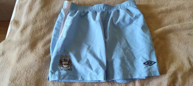 Umbro Manchester City FC Heimfußball-Fußball-Shorts für Jungen XL, 13–14 Jahre