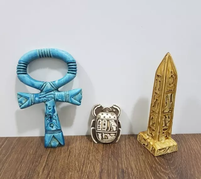 Ancient Egyptian amulets of the scarab beetle, the obelisk, and the key to life