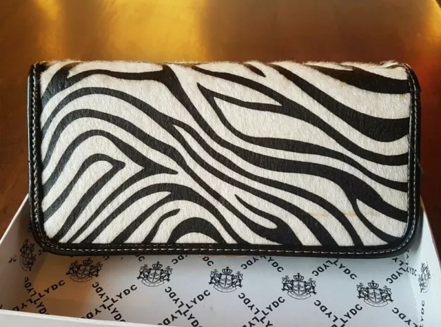 Premium Photo | Zebra print purse with black handle and pink lining  generative ai