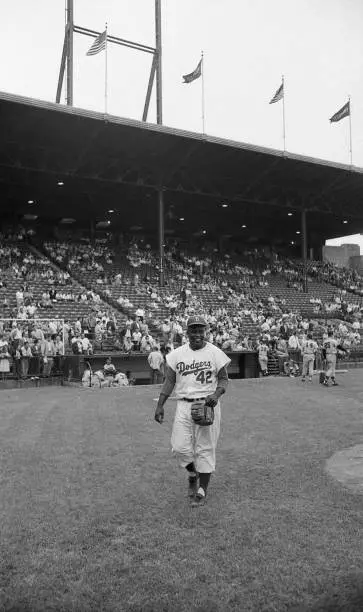 Brooklyn Dodgers Jackie Robinson walks on the field vs St. Louis C - Old Photo