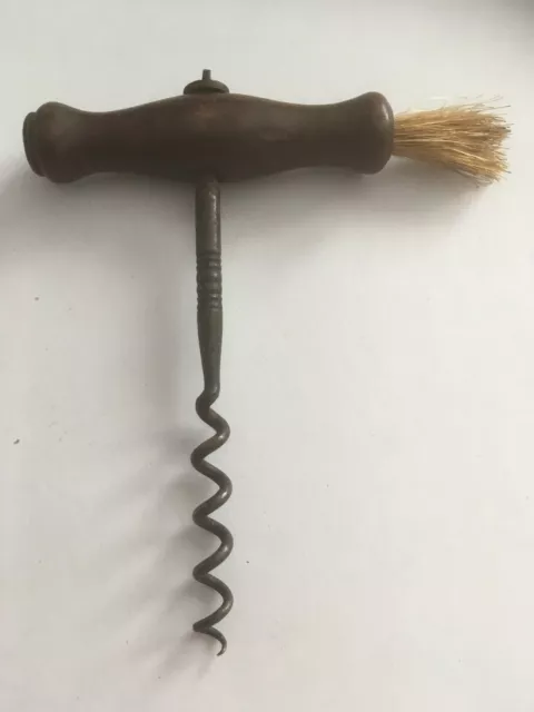 Antique corkscrew with wooden handle and dusting brush