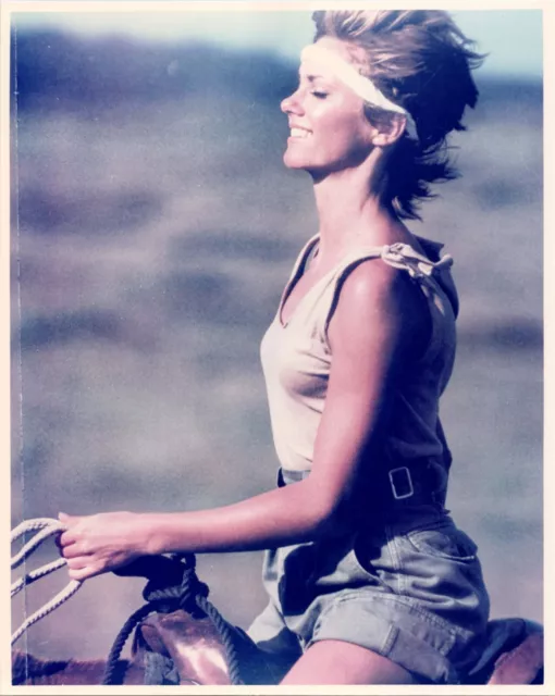Olivia Newton John smiling in shorts & sleeveless top riding horse 8x10 photo