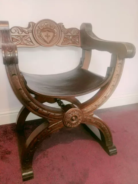 Antique 20th Century hand carved oak Savonarola/x frame chair with leather seat