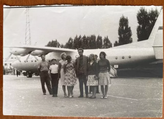 Beautiful guys and girls near the airplane. Vintage photo