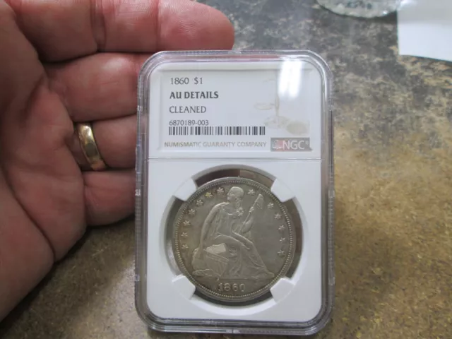 1860 SEATED LIBERTY DOLLAR Coin IN NGC ABOUT UNCIRCULATED CONDITION CLEANED