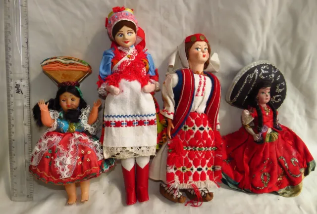 4 medium sized costume dolls