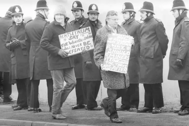 Police patrol the picket line during the Miners' Strike while a mi- Old Photo