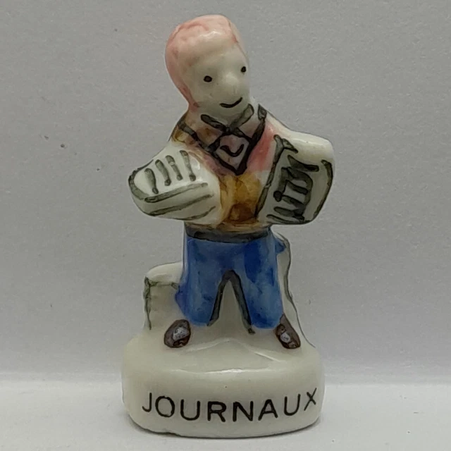 Fève Journaux en porcelaine Nordia 1994 (B26G)