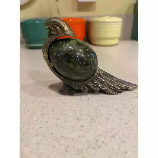 Bronze bird with spherical stone