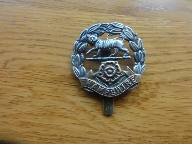 HAMPSHIRE REGIMENT CAP BADGE WITH BRAZING HOLES  and 75332 stamped on slider