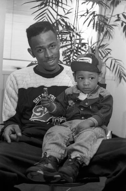 RAPPER MC SHAN poses for a portrait with his son, Little Shan, on - Old ...