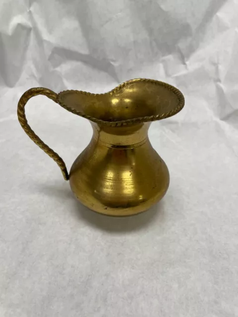 Small Solid Brass pitcher from India measures approx 4" tall 2.75" wide