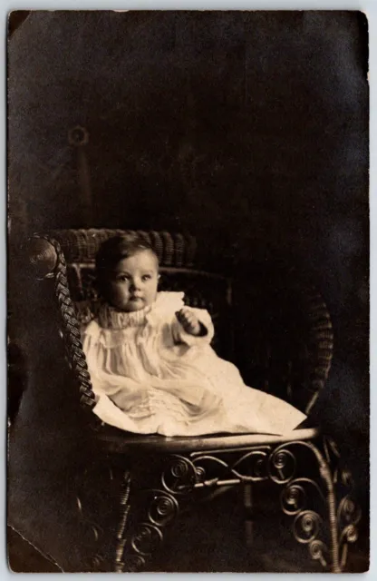baby seated on wicker chair in studio RPPC 1911 Hohhof Studio Chicago Illinois