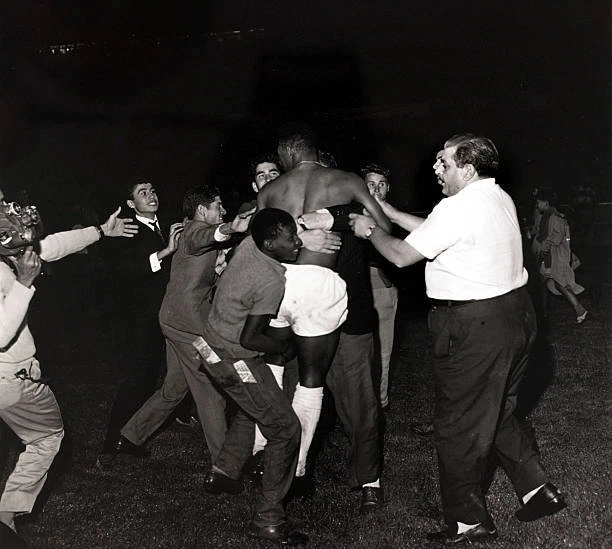 1962 SANTOS AND Brazil star Pele is mobbed by excited youngsters a Old