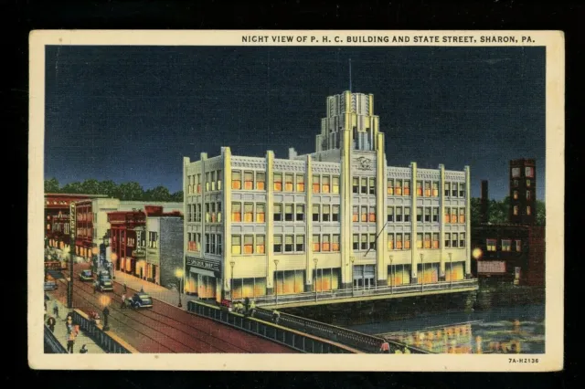 Pennsylvania PA postcard Sharon PHC Building stores State Street evening view