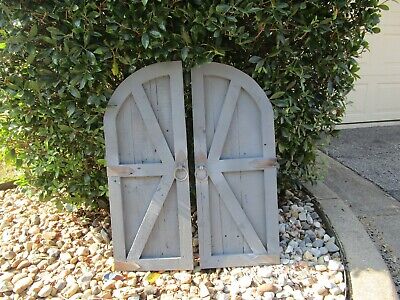 Pair of gray vintage inspired round top barn doors with hardware wall decor