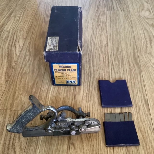 RECORD No 044  VINTAGE PLOUGH PLANE ,WITH GOOD SET OF8 CUTTERS, BOXED