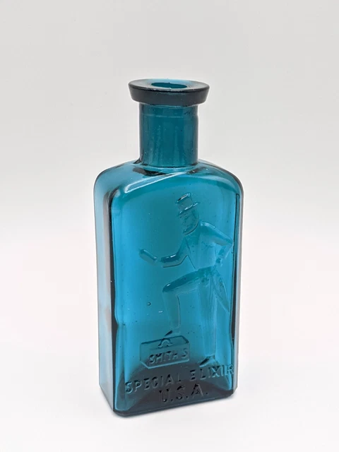 Vintage Crownford Smith's Special Elixir USA  Blue Glass Bottle Top Uncle Sam