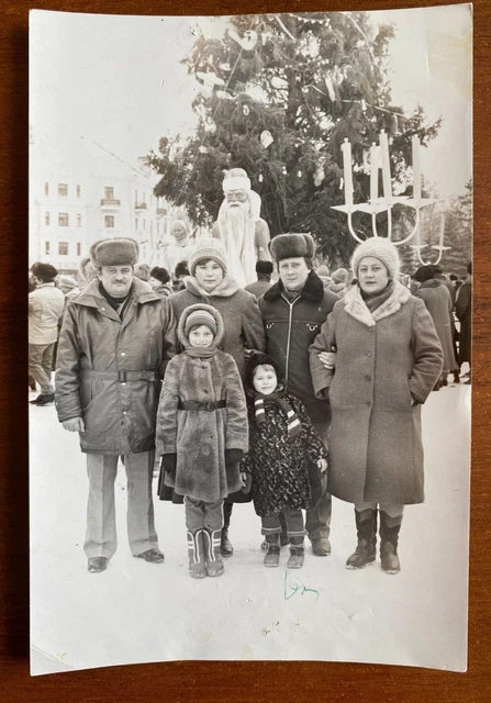 Beautiful guys and girls with children near the Christmas tree. Vintage photo