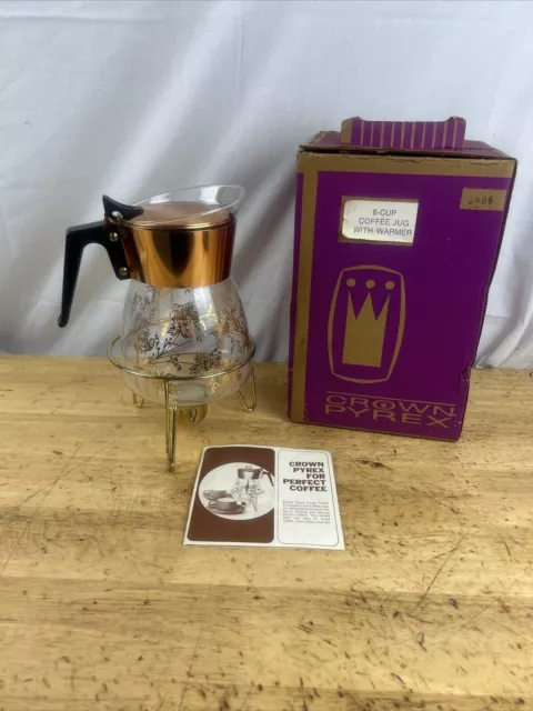 https://www.picclickimg.com/44oAAOSwcL1lY-Fi/Vintage-Retro-Crown-Pyrex-Clear-Gold-Coffee-Jug-Warmer.webp