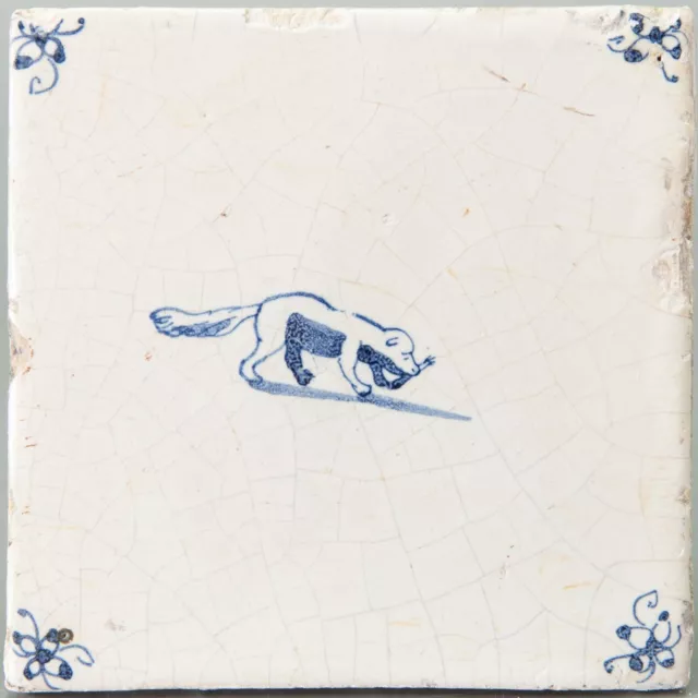 Nice Dutch Delft Blue animal tile, dog with a bone, 17th. century.
