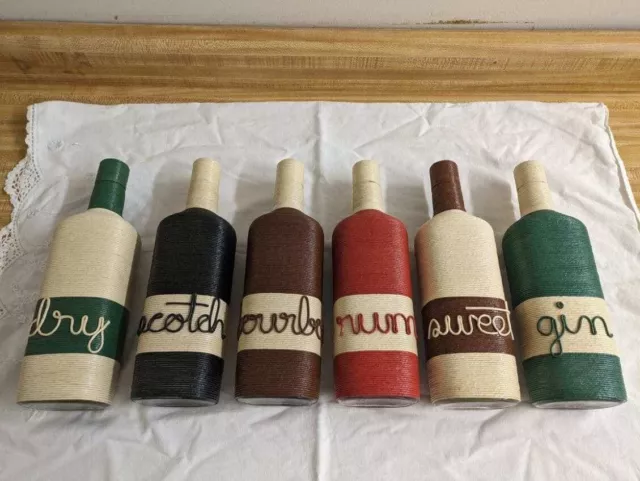 Vtg. MCM colored string covered bottle liquor set; set of 6.