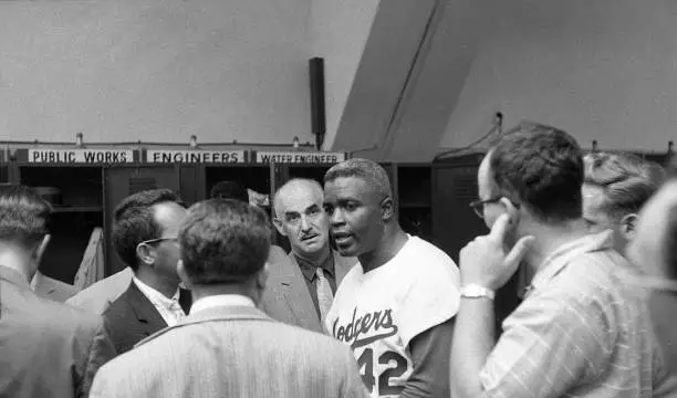 Brooklyn Dodgers Jackie Robinson talking in locker room after game - Old Photo