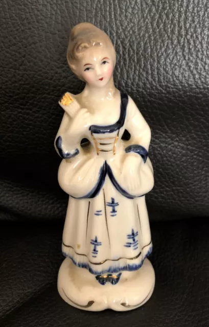 Vintage porcelain figurine of a Victorian lady holding a fan, blue & white dress