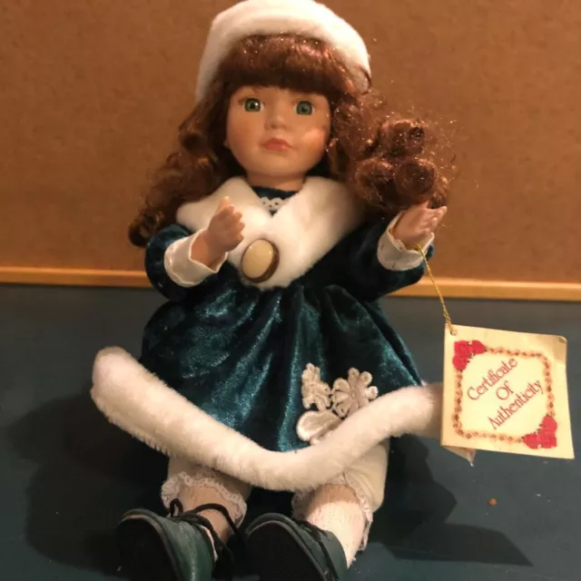 Collectors Choice 9 in tall sitting porcelain doll. Plays music and moves.