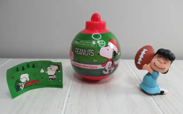 Peanuts Christmas figure Lucy holding football opened blind surprise ornament