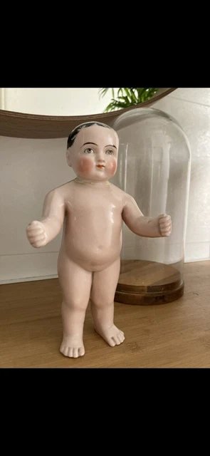 A PORCELAIN FROZEN CHARLIE DOLL, from around 1900
