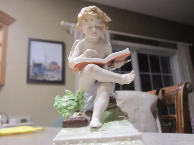 Porcelain Angel with book  Scheibe-Alsbach, Germany, early 20th century  5 1/2 "