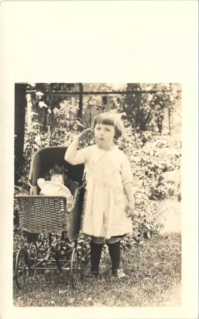 LITTLE GIRL & TOY DOLL IN WICKER STROLLER antique real photo postcard rppc c1910